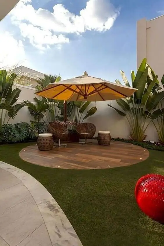 The Corner Patio: Set away from the house in the yard's far corner, with a cantilevered umbrella, rattan seats and