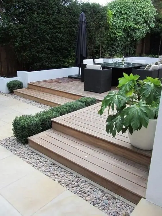 Wood and Pebbles deck and patio: A pocket of white pebbles set into pale, weathered decking. It's a day-spa trick and it