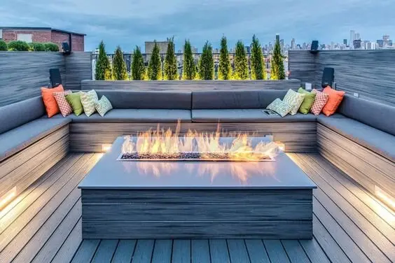 Firepit Hub deck and patio: A low concrete fire pit in the centre doubles as a coffee table for the ten months a year it