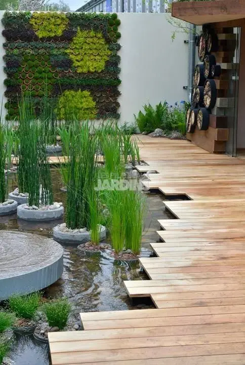 Water’s Edge deck and patio: The boards run out at uneven lengths right up to the pond, so the water reads as part of the
