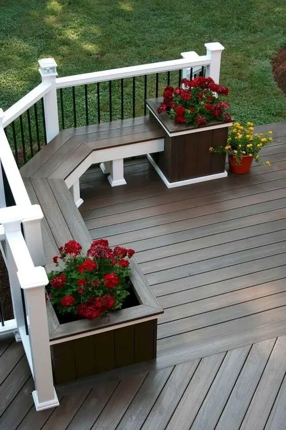Farmhouse Charm deck and patio: White timber balustrade with iron spindles, flower boxes on the rail, timber decking