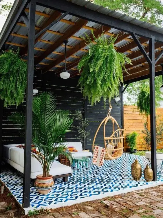 Bright Moroccan deck and patio: Tin roof, black timber frame, and then the floor takes over: blue and white