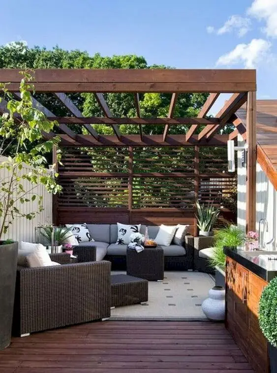 A Cosy Lounge deck and patio: That dead corner behind the garage can carry a deck. This one uses a pergola and privacy