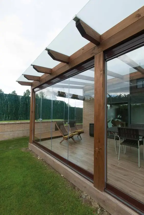Glass Enclosed Patio: Glass walls under a clear-roofed pergola, so the space still works in a howling westerly. It's