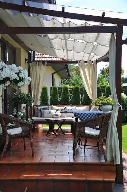 Curtained Patio: An old stone patio doesn't need demolishing. Refinish the floor, add a clear-roofed pergola, then hang