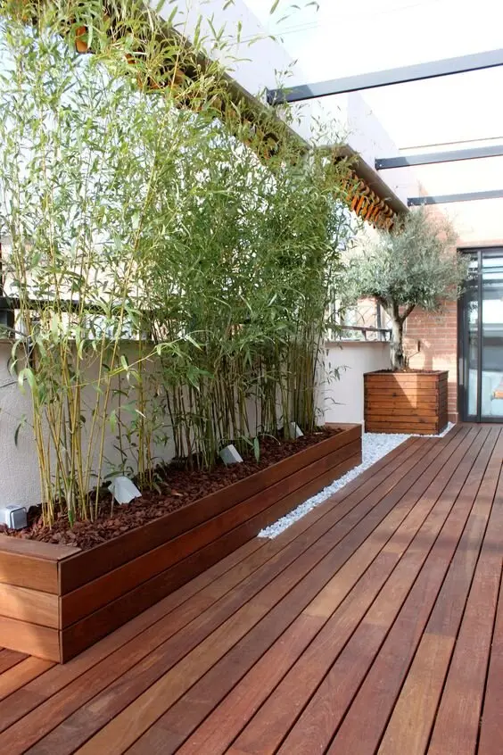 Bamboo Shade deck and patio: Potted bamboo along the deck edge works as a living privacy screen, and the rustle is half the