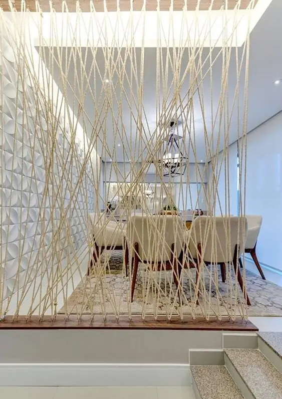 Roped Division DIY room divider: Modern with a touch of rustic. This sisal rope room screen effectively separates the space