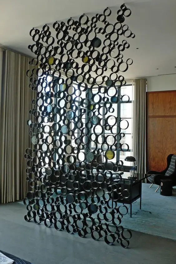 Pipe Network DIY room divider: This modern, arresting and sleek room divider is made out of common PVC pipes! Using