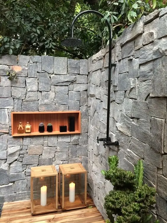 Recessed Wall Shelves outdoor shower: Stacked stone, matte black tapware, timber floors and a recessed, wood-lined shelf for