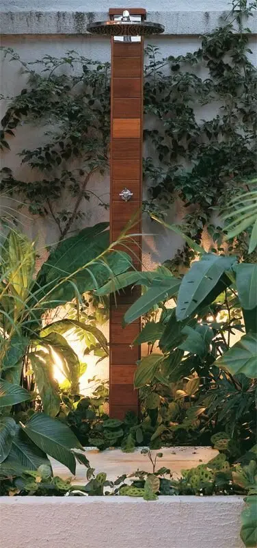 Outdoor Lights outdoor shower: A rustic pole, chrome fittings, flat concrete and a scatter of low garden lights. Lighting is