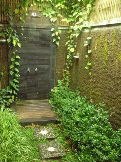 Green Paradise outdoor shower: A shower buried in moss, climbers and shrubs, reached by stepping stones. The wilder the