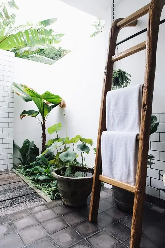 Rustic Towel Rack outdoor shower: White subway tiles with a ladder towel rack leaning beside the shower. The ladder holds