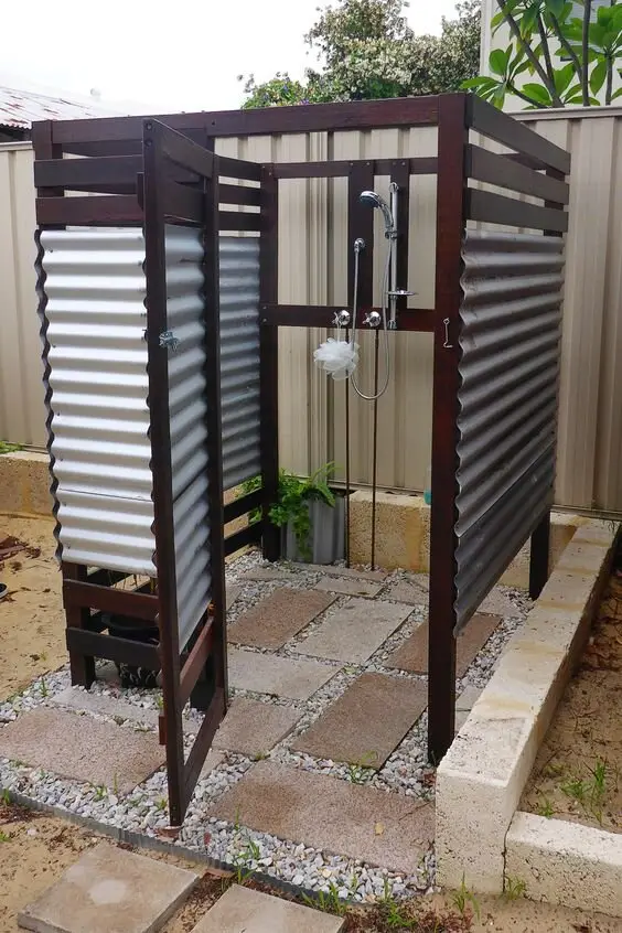 Easy DIY outdoor shower: Galvanised sheet walls, some timber framing, paint, concrete slabs and pebbles for the floor, all
