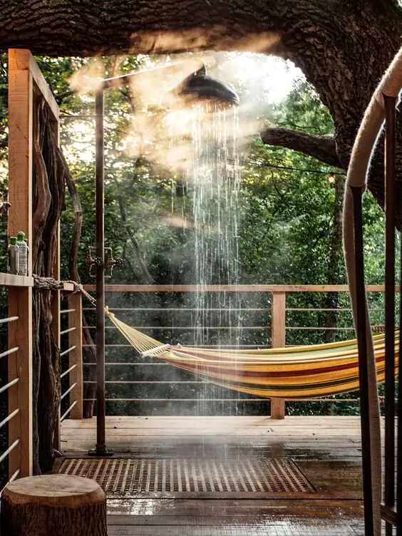 Treehouse Balcony Shower: A shower on a private balcony among the trees, with timber boards and iron pipe railings. Check