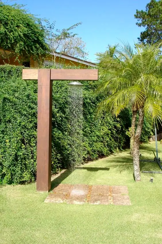 Backyard Shower Post: A single sturdy post carrying the pipes, a rain head on top, stone slabs to stand on. This is the