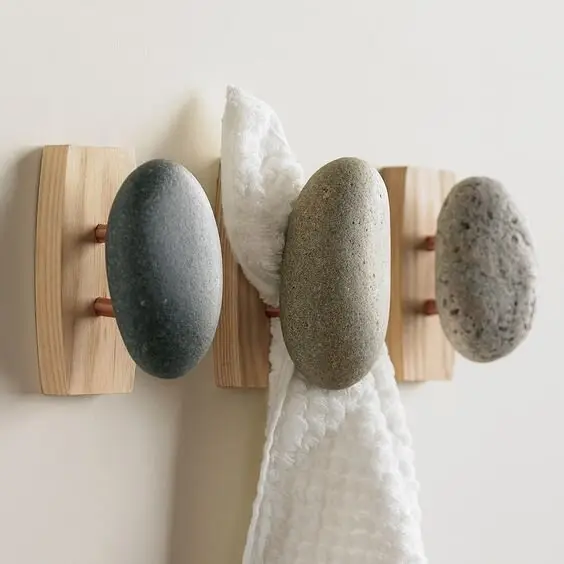 Stone Hooks outdoor shower: Stone and timber hooks for towels and clothes and the shower caddy. Small detail, big