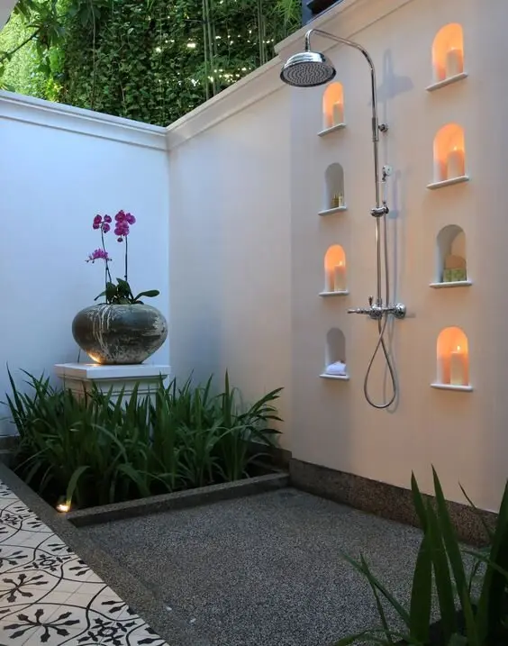 Spa-Inspired Nook outdoor shower: Candles, orchids, pebbled concrete and greenery, arranged like a day spa that escaped. The