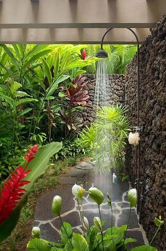 Tropical Paradise outdoor shower: A shower tucked into a corner of dense planting, screened by the garden itself