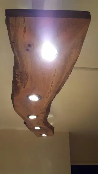 Wood Beam Lighting wood project: A live-edge slab drilled for pendant bulbs, hung over the dining table or island. The beam