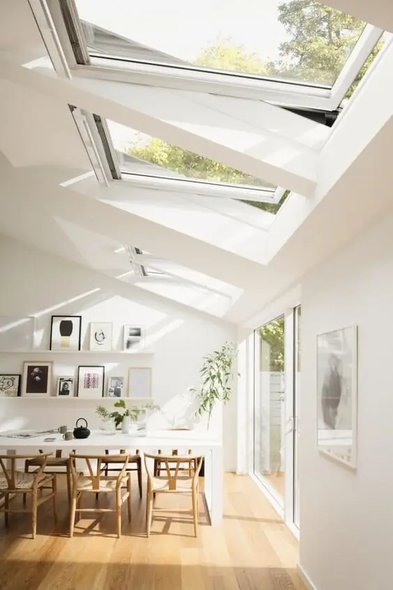 white dining room with skylights