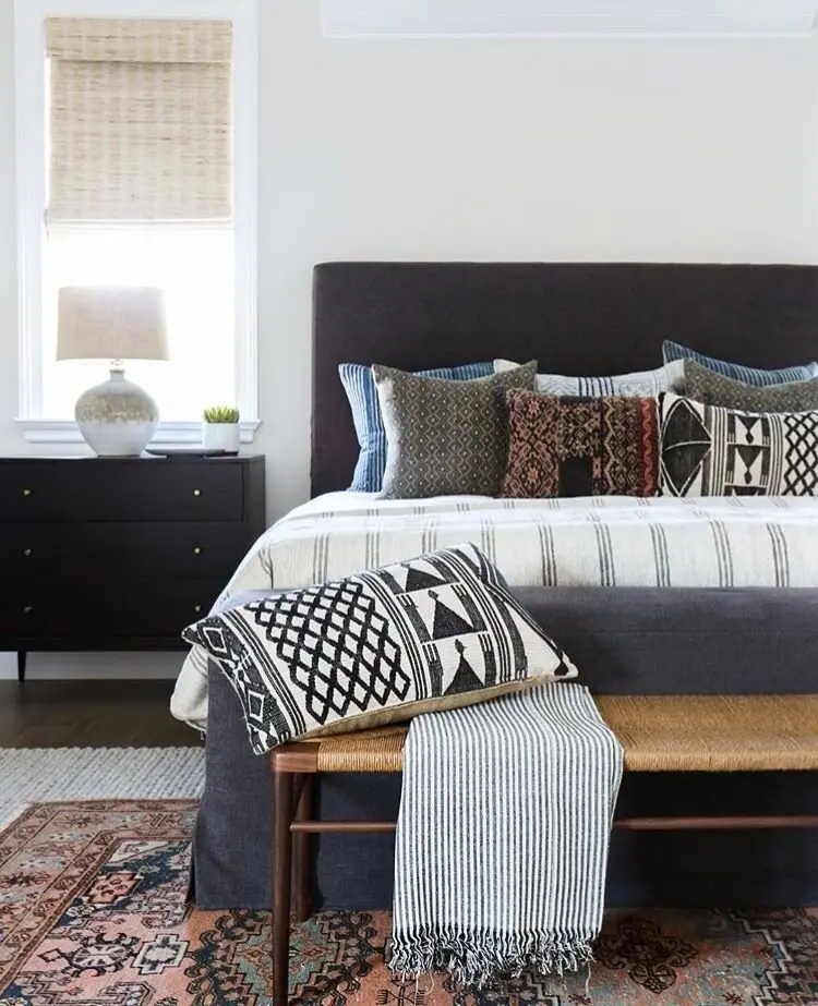 Elegant Boho bedroom: A neat, classic room loosened up with boho pattern on the rug, the shams and the covers