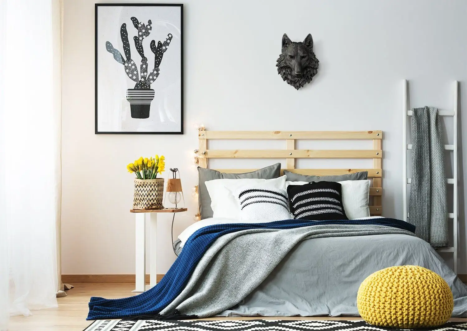 Perky Hippie bedroom: Yellow accents over a neutral base, a DIY headboard, a towel ladder, a patterned rug