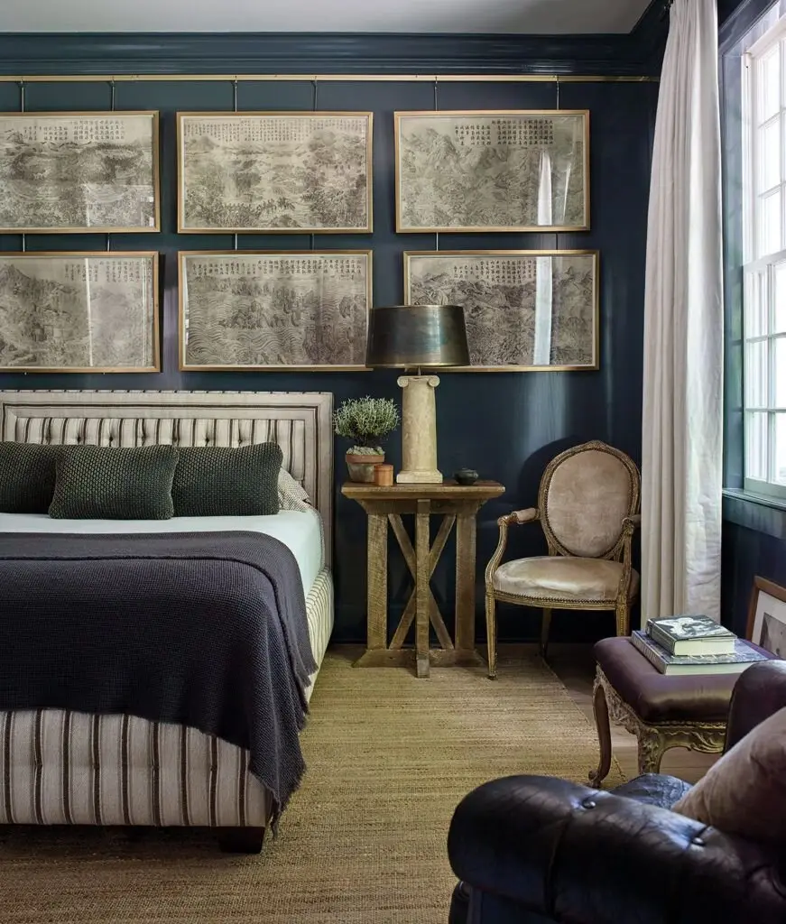 Chic Vintage bedroom: An antique French armchair, sepia prints, a tufted bed and starched white curtains