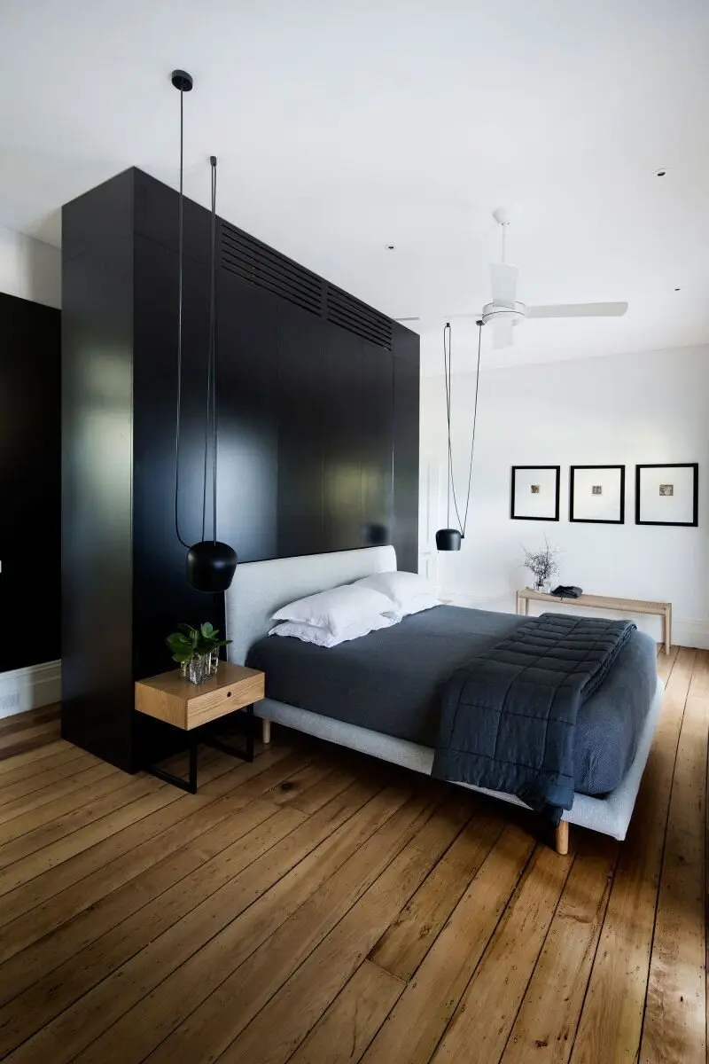 Rustic Minimalist bedroom: Timber plank floors and a vintage ceiling fan on the rustic side