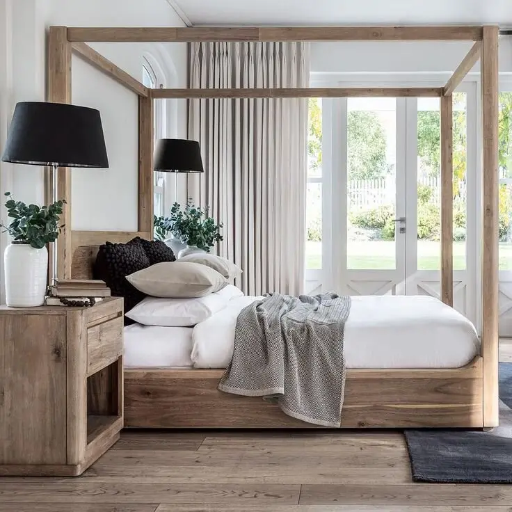 Updated Four-Poster bedroom: A four-poster stripped of every curl and finial, down to plain rustic beams