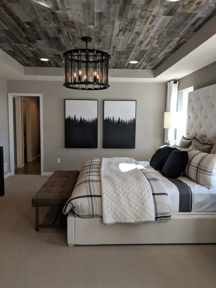Rustic Elegance bedroom: A white tufted headboard and tailored bench under a rough timber ceiling and a black vintage