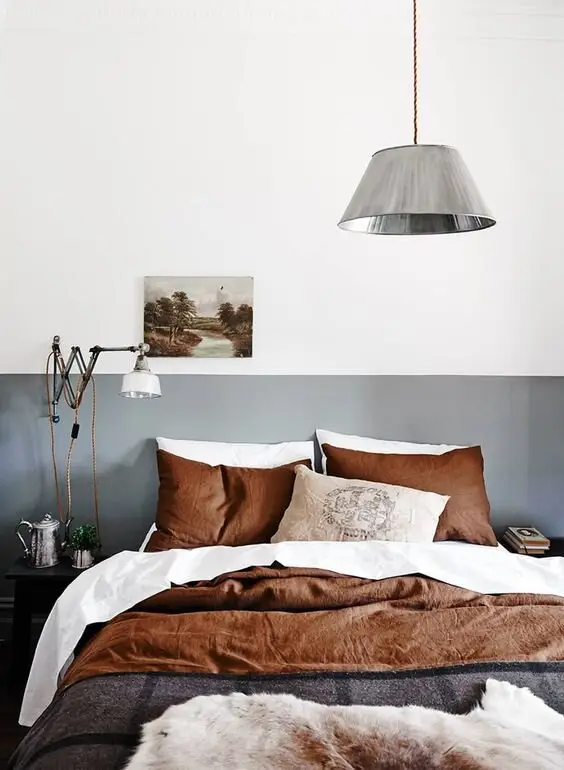 Updated Farmhouse bedroom: Farmhouse with the clutter stripped out: two-toned neutral walls, one vintage pendant, a big bed