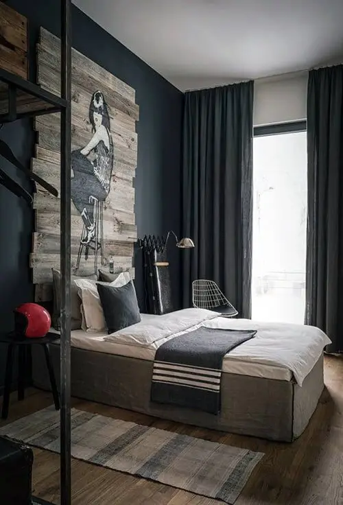 Edgy Vibes bedroom: Grey walls, bare boards, metal accents and a pallet-wood art piece doing the talking