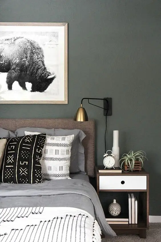 Tamed Country bedroom: Earth tones, traditional patterns and one large bull print on the wall