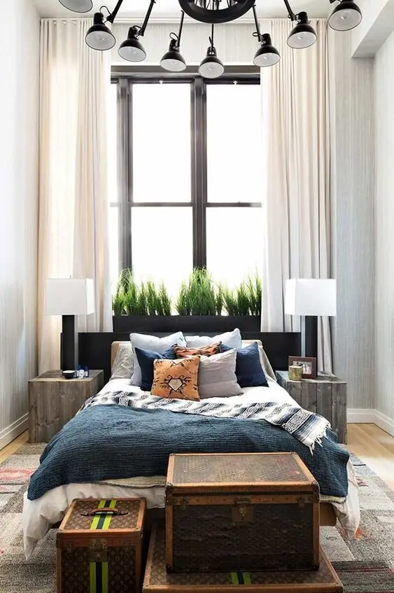 Vibrant Fascination bedroom: High ceilings, floor-to-ceiling curtains and a stack of vintage luggage as the accent