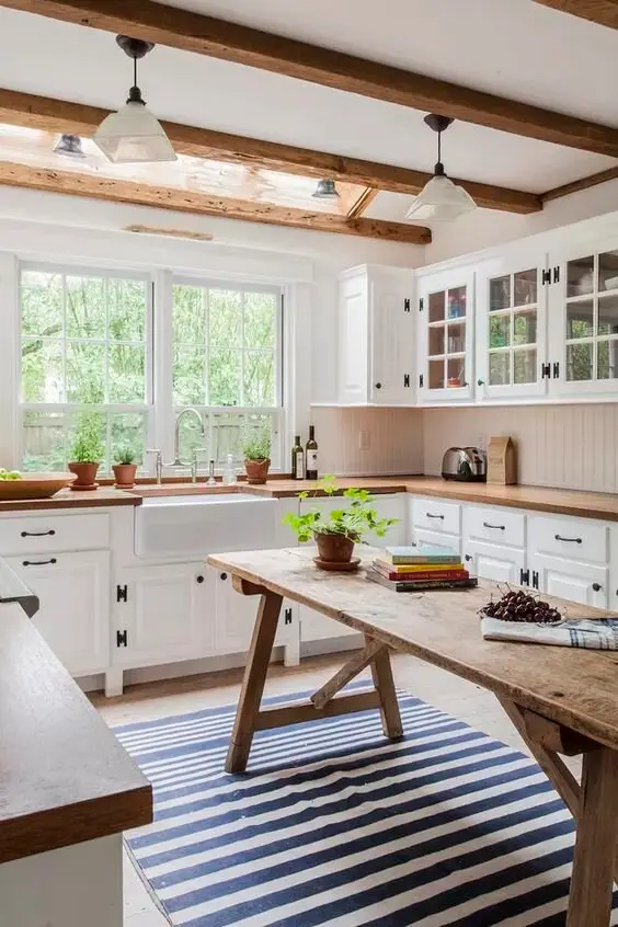 DIY Island farmhouse kitchen: A sturdy secondhand table standing in as the island. No plumbing, no stone, no joinery bill