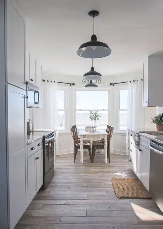 Charming Bay Windows farmhouse kitchen: A bay window at one end of the kitchen buys you light, a view and a nook deep enough