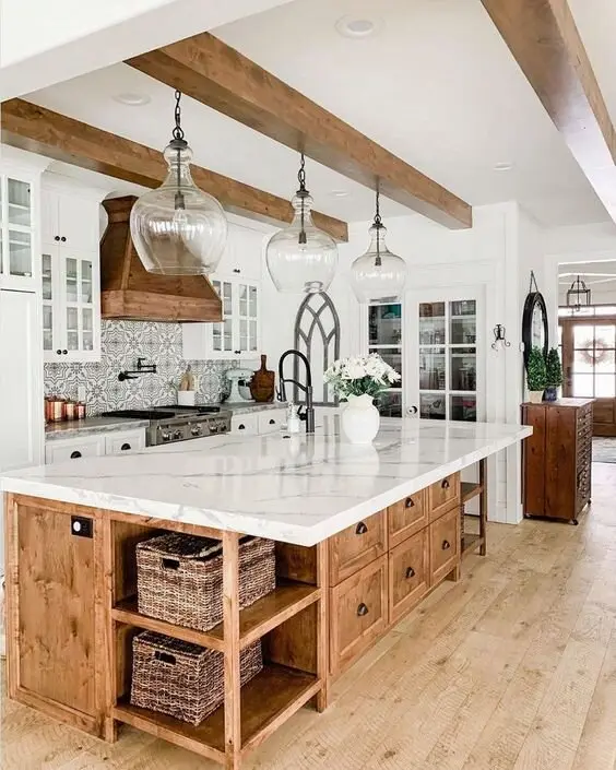Marbled Opulence farmhouse kitchen: A big working island, practical storage below and marble above. If real marble scares