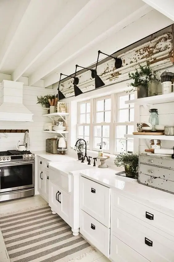 Shabby Charms farmhouse kitchen: White shiplap and cabinetry with black hardware carried through everything: handles, tap