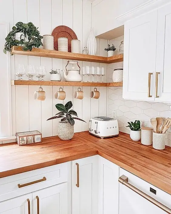 Copper Tones farmhouse kitchen: White kitchen, red oak counters and shelves, brushed copper handles. Copper warms white the