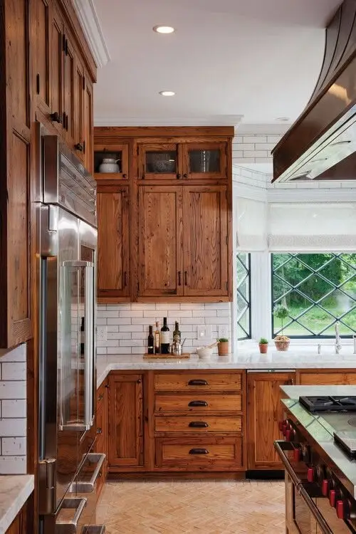 Lotsa Wood farmhouse kitchen: Timber cabinetry across nearly every wall, balanced by a white ceiling, marble counters and