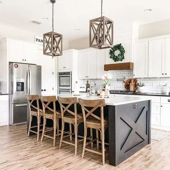X-Factor farmhouse kitchen: The X-frame repeated across the island, the stools and the pendants. It comes from an era when