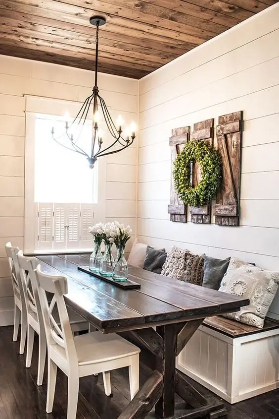 Nook Dining farmhouse kitchen: A corner dining nook that still seats six, with an X-frame table under a classic chandelier