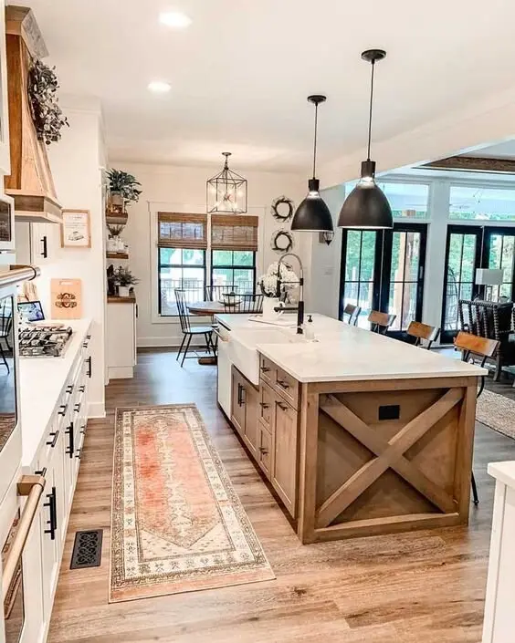 Rustic Island farmhouse kitchen: An X-frame island big enough to anchor the whole kitchen, with an apron sink set into a