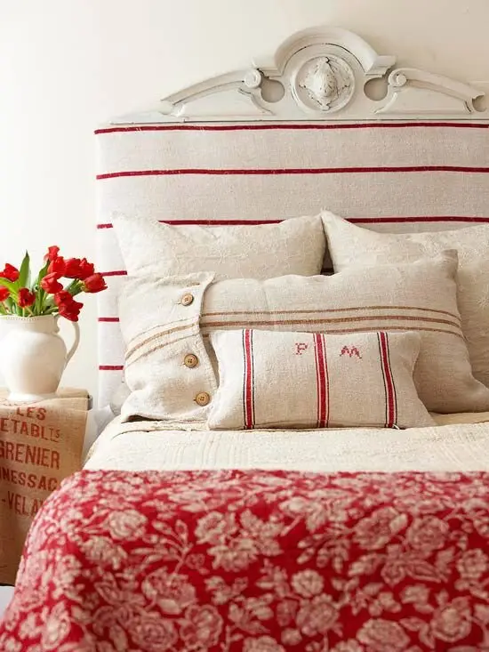 Red Sailor coastal bedroom: Grain sack fabric, burlap pillows and a carved shabby chic headboard, with red nautical stripes