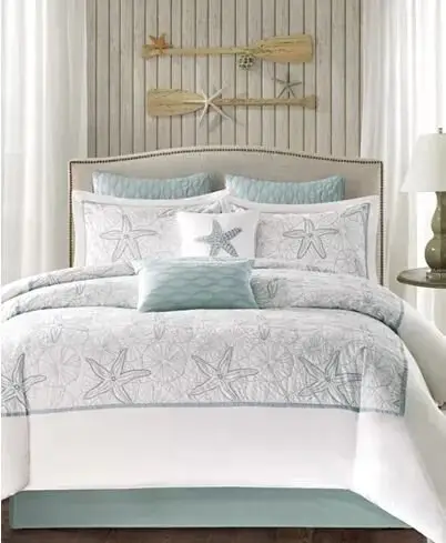 Beachfront Stars coastal bedroom: Starfish on the sheets, in the accent wall and around the room, with paddles and turquoise