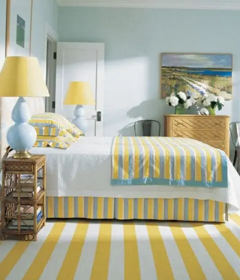 Sunshine Cove coastal bedroom: Yellow lamps, sheets and carpet over light mint walls, with baby blue lamps as the bridge