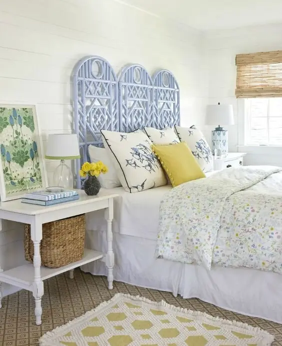 Lakehouse Cottage coastal bedroom: Shiplap, a cornflower rattan headboard, a coffee-toned patterned rug and dandelion