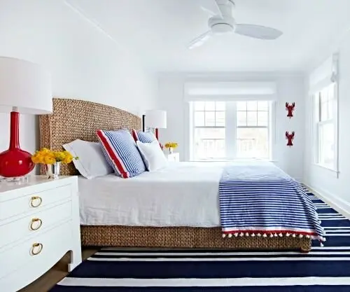 Nautical Colours coastal bedroom: Crimson and navy with a little Tuscan yellow over clean white. Striped rug, eagle