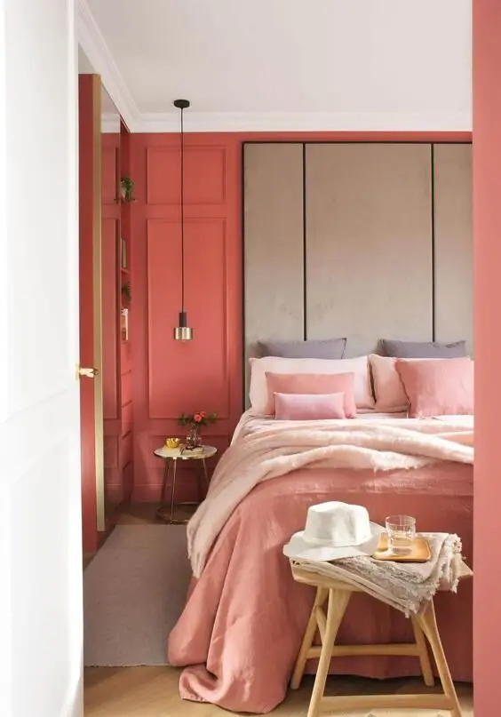 Warm Corals coastal bedroom: Coral pinks instead of the usual blue: punchy walls, layered pink sheets, a sandy accent wall