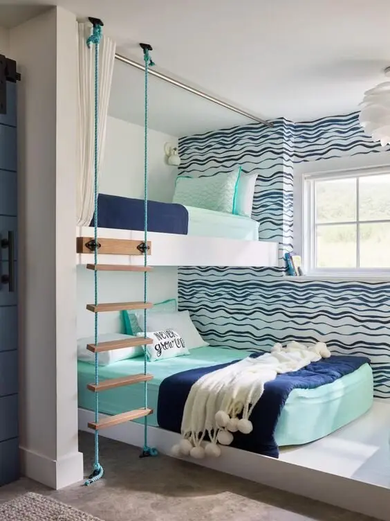 Beach Boys coastal bedroom: Wave wallpaper, bunk beds and a rope ladder to the top bunk. Kids' coastal can be as literal as